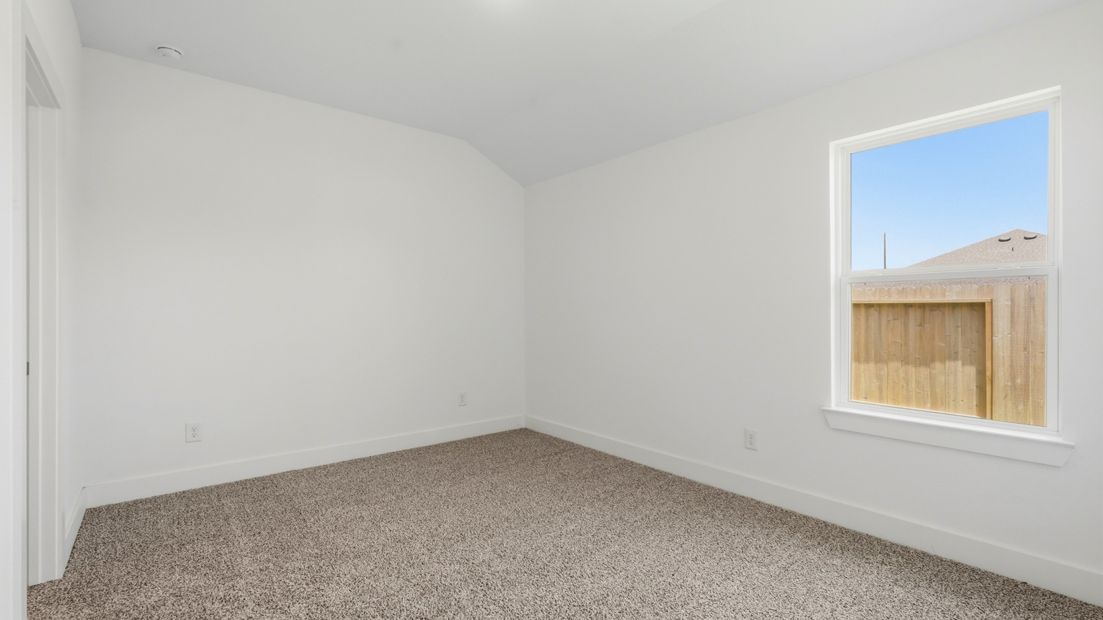 Secondary bedroom with carpet flooring