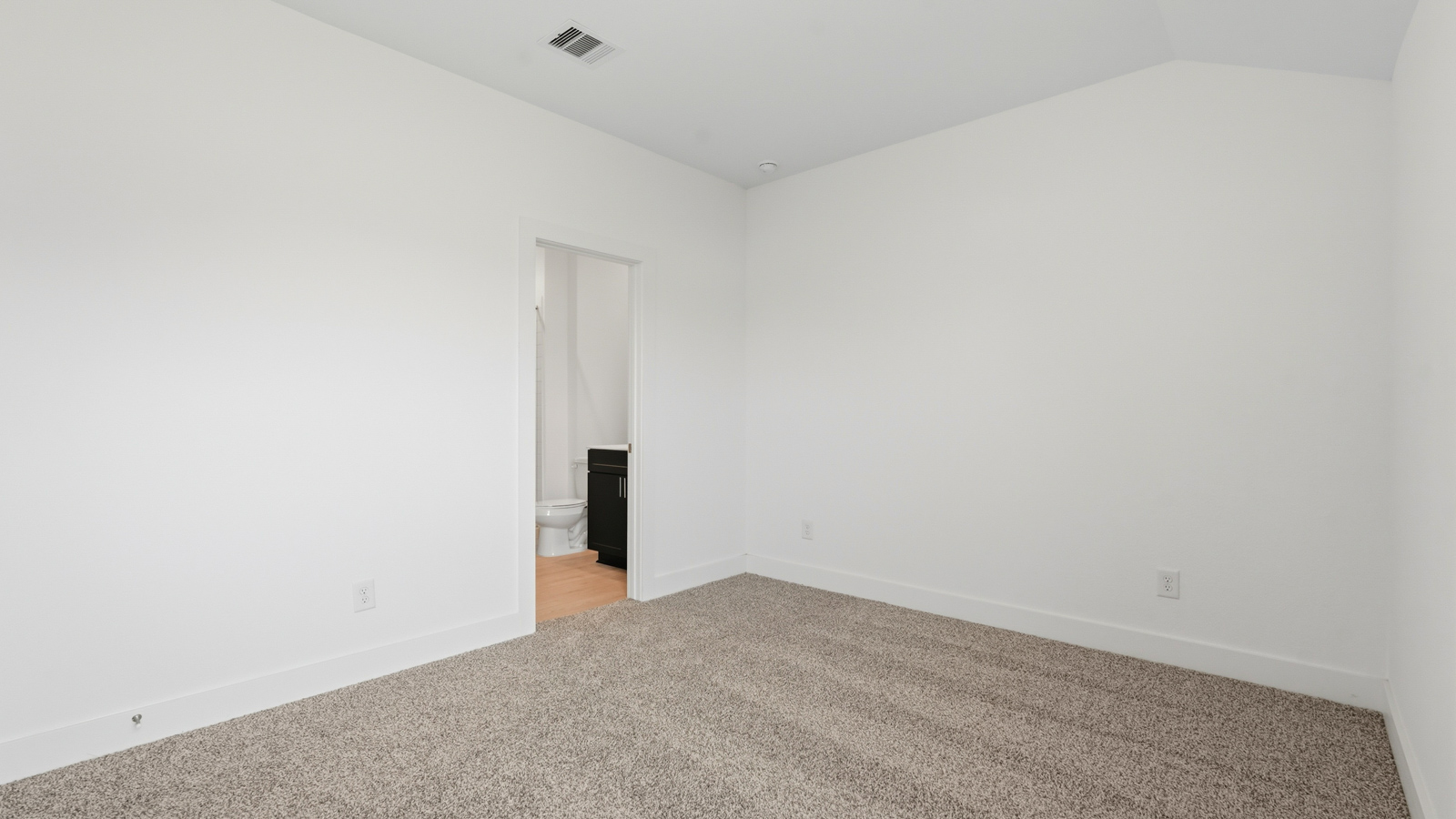 Secondary bedroom with carpet flooring
