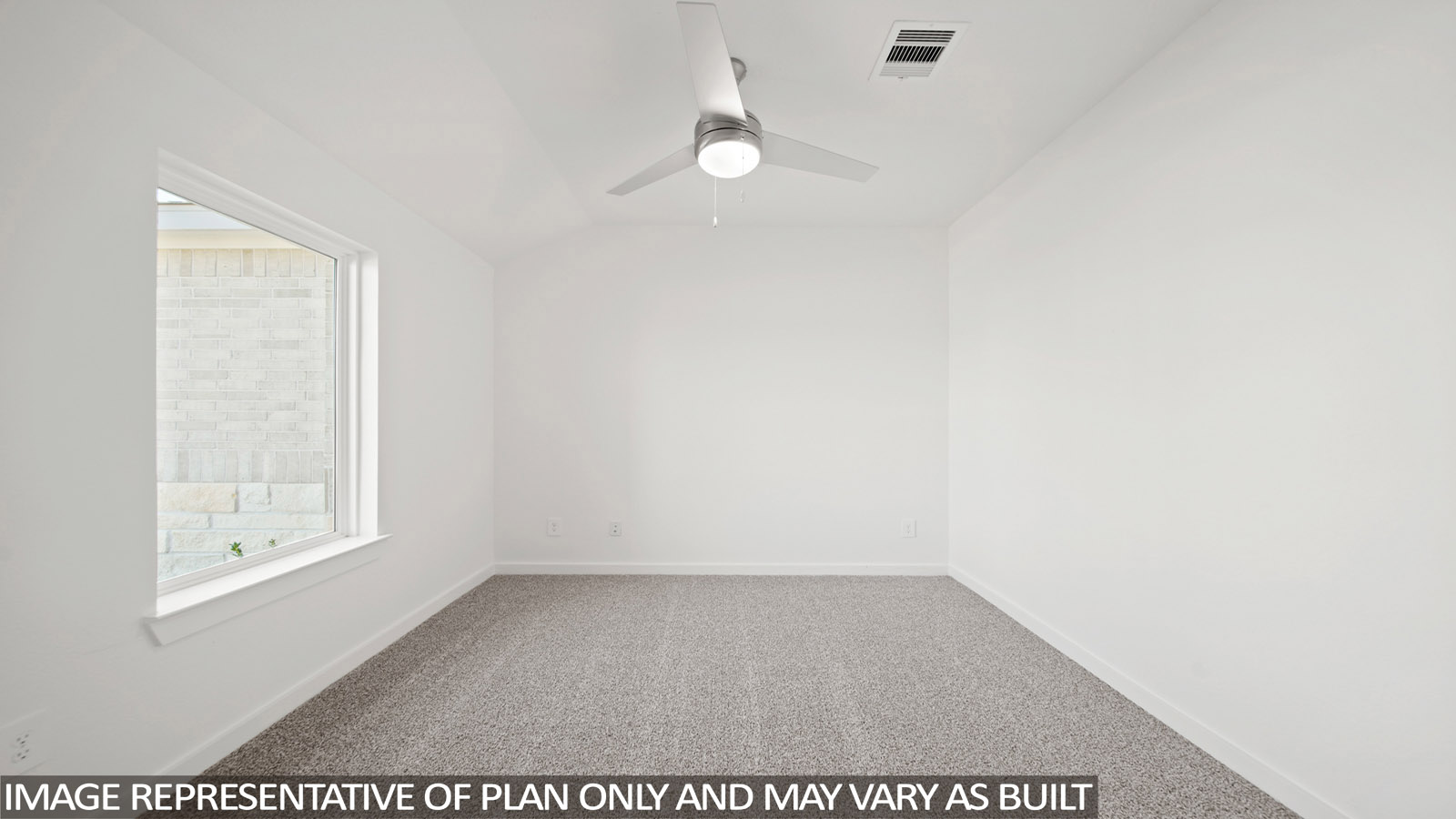 Secondary bedroom with carpet flooring