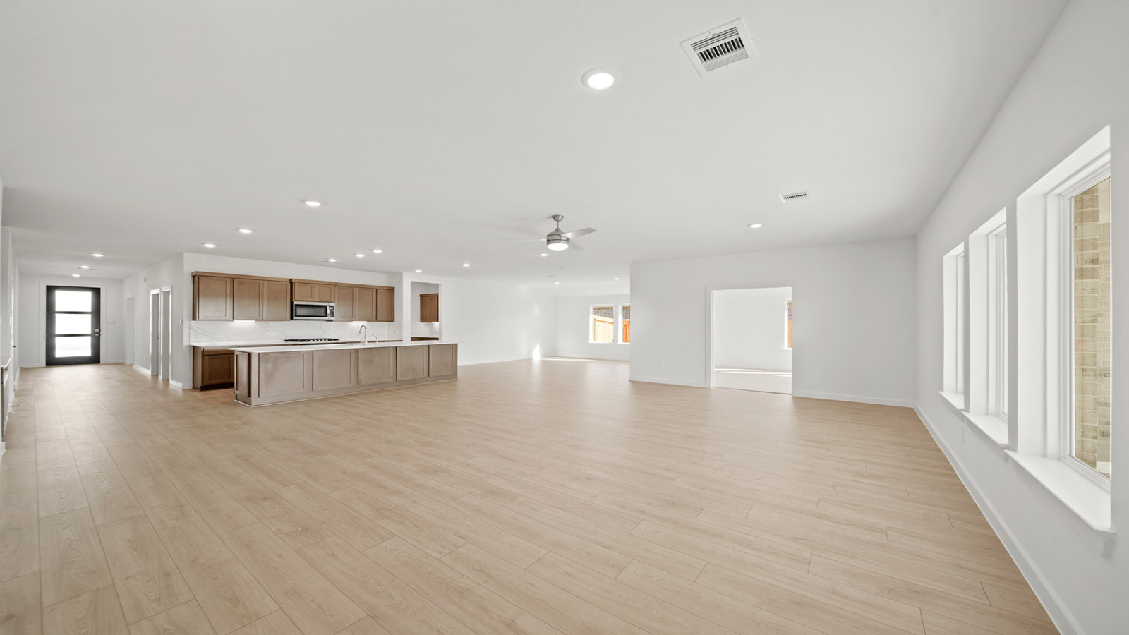 Spacious living area with vinyl flooring