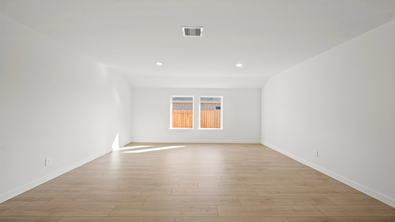 Spacious living area with vinyl flooring