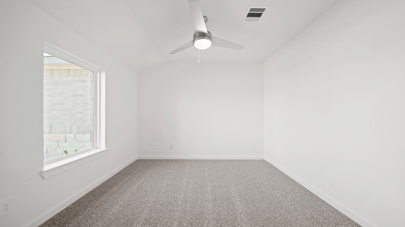 Secondary bedroom with carpet flooring