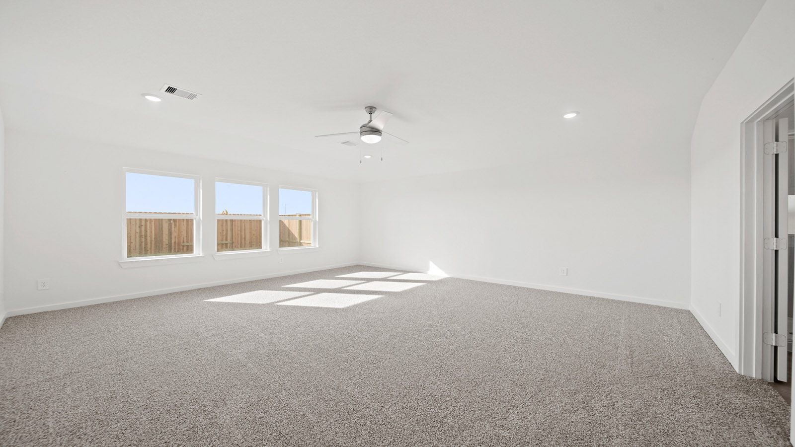 Primary bedroom with carpet flooring