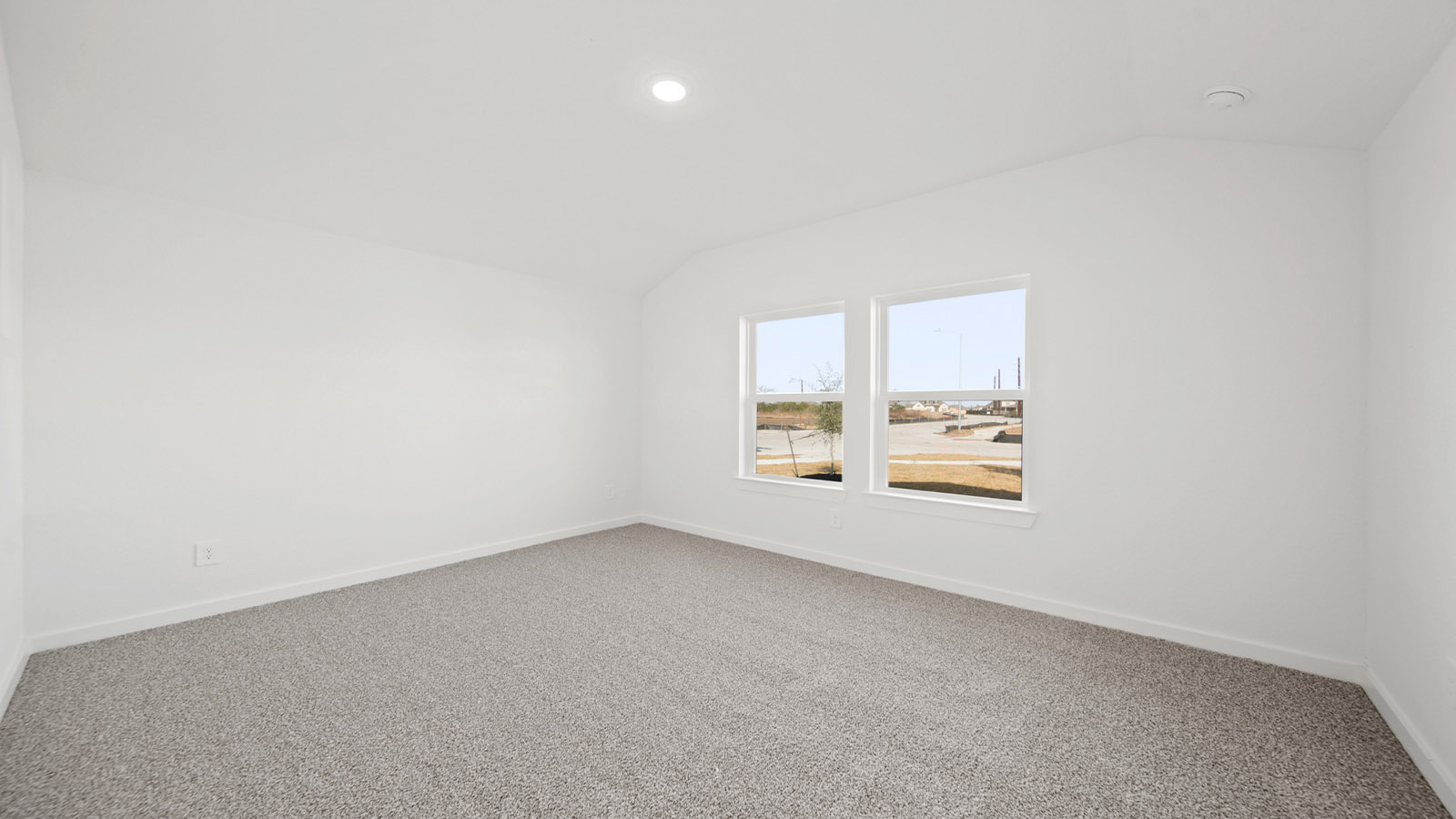 Secondary bedroom with carpet flooring