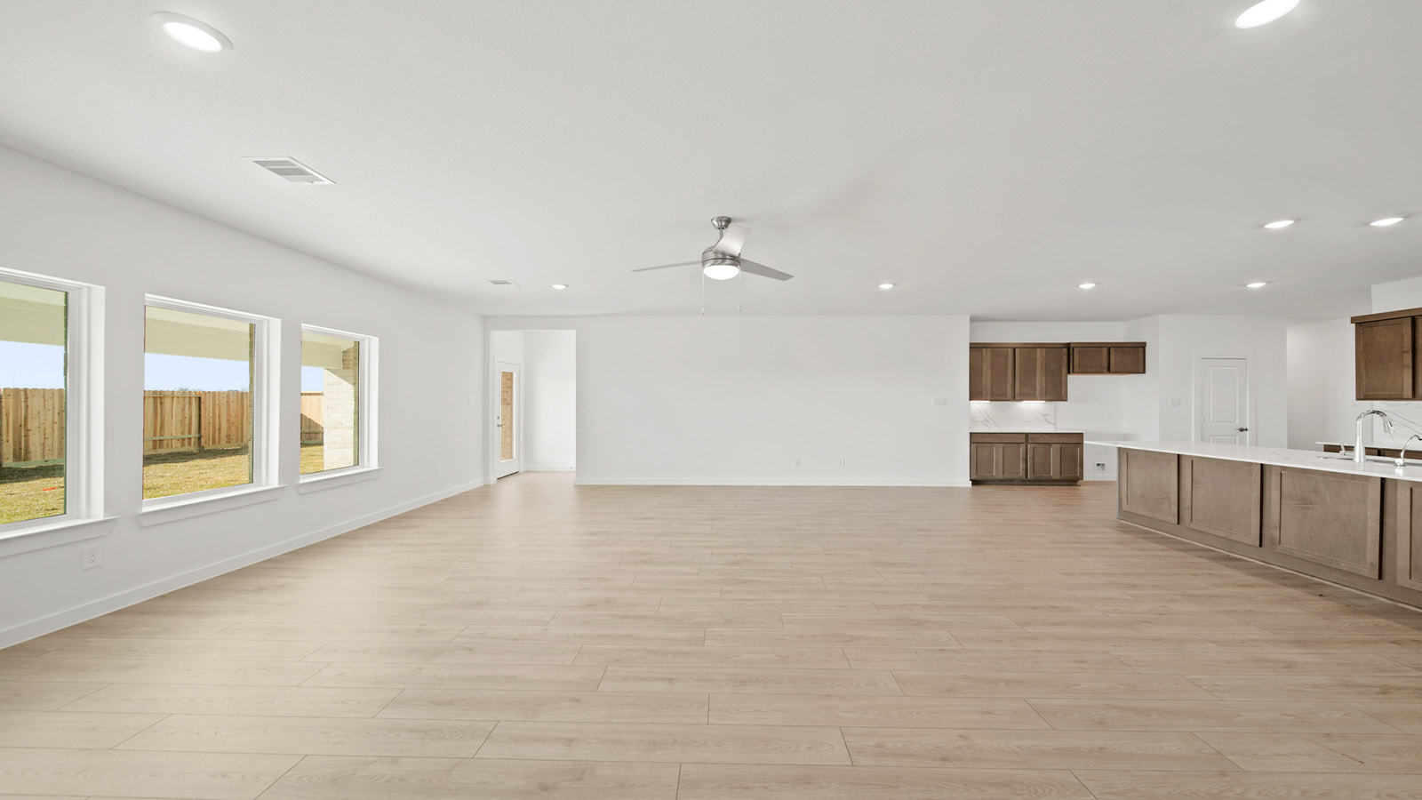 Spacious living area with vinyl flooring