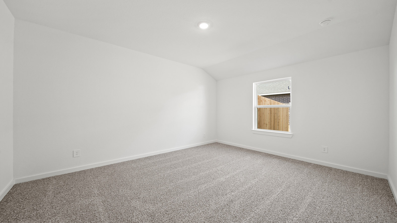 Secondary bedroom with carpet flooring