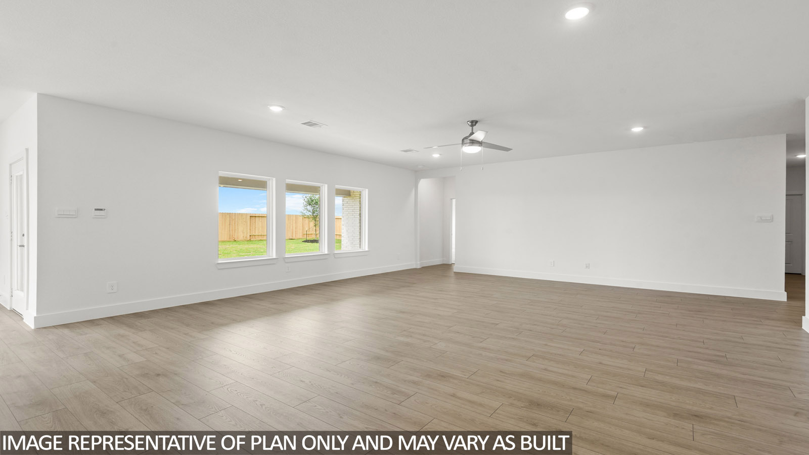 Spacious living area with vinyl flooring
