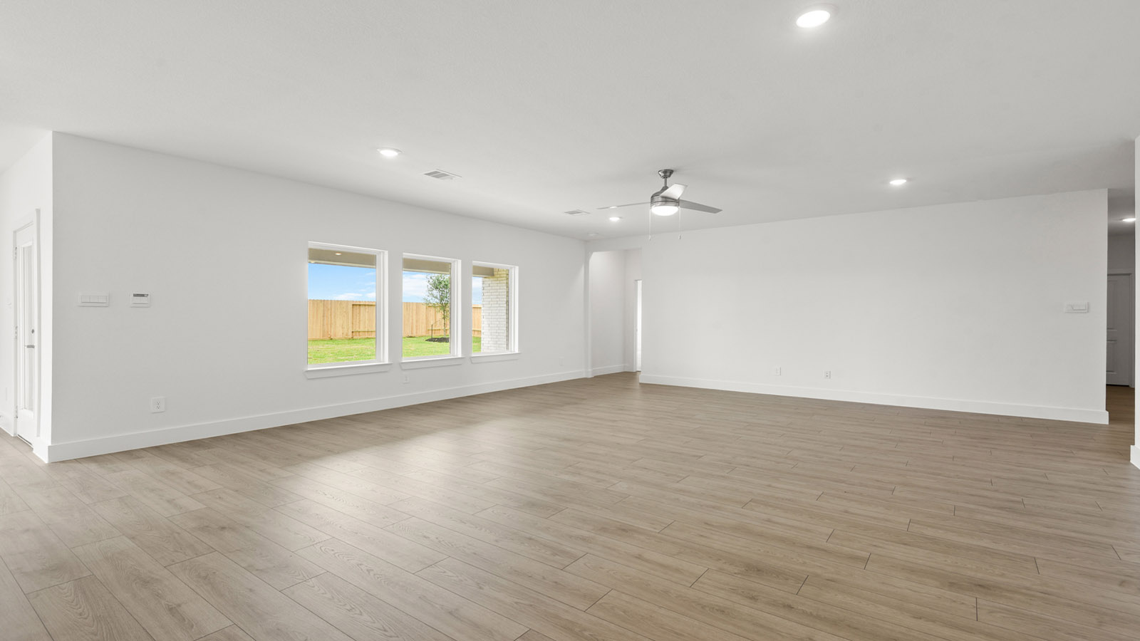 Spacious living area with vinyl flooring