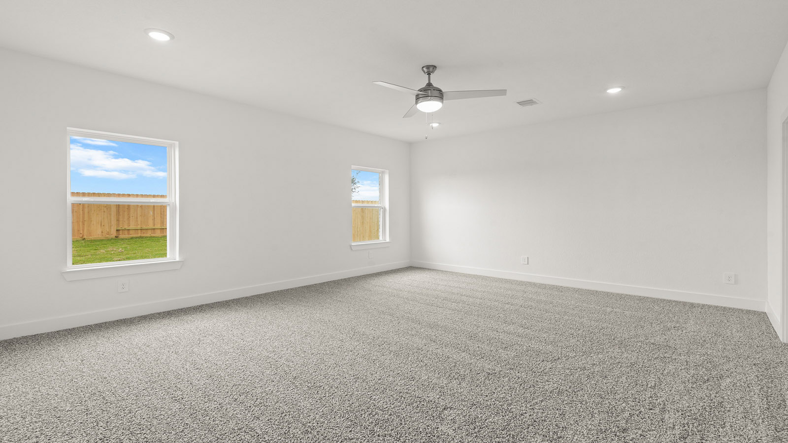 Primary bedroom with bright windows