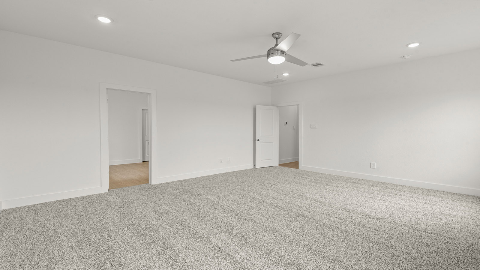 Primary bedroom with carpet flooring