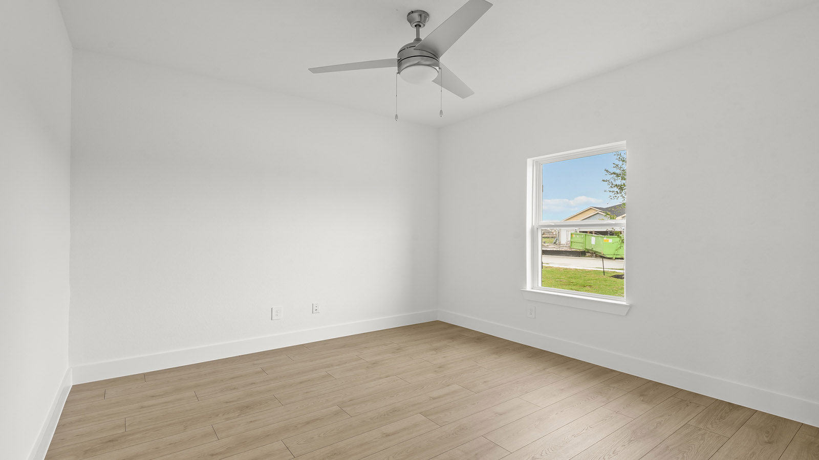 Spacious living area with vinyl flooring