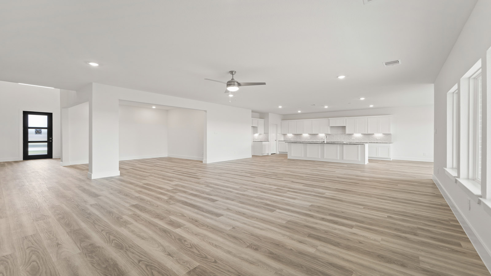 Spacious living area with vinyl flooring