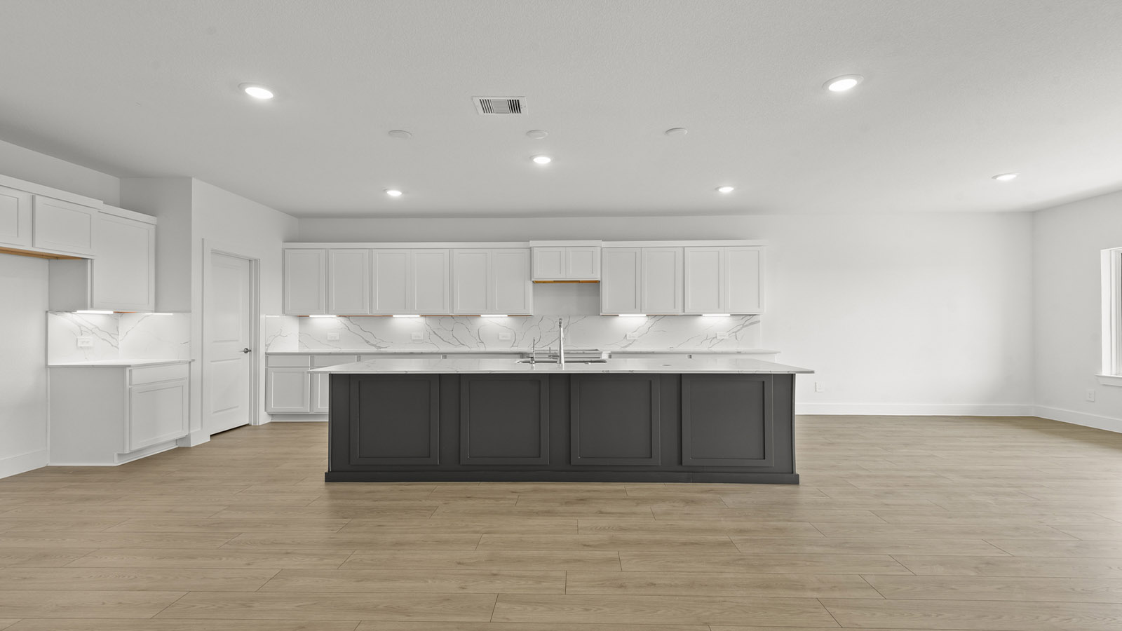 Kitchen with an island and vinyl floor
