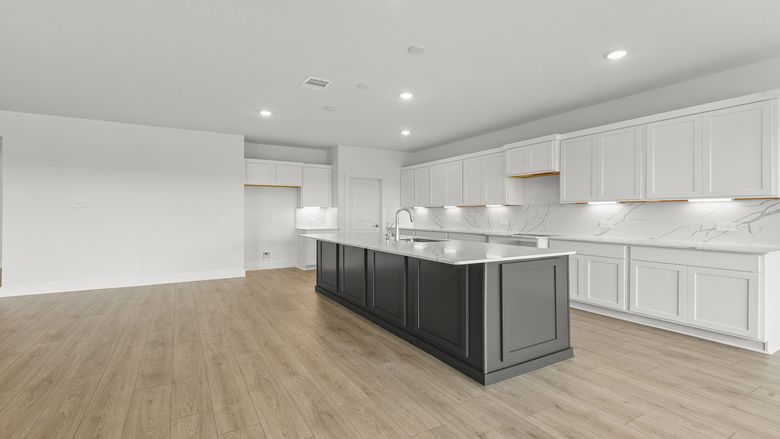 Kitchen with an island and vinyl floor