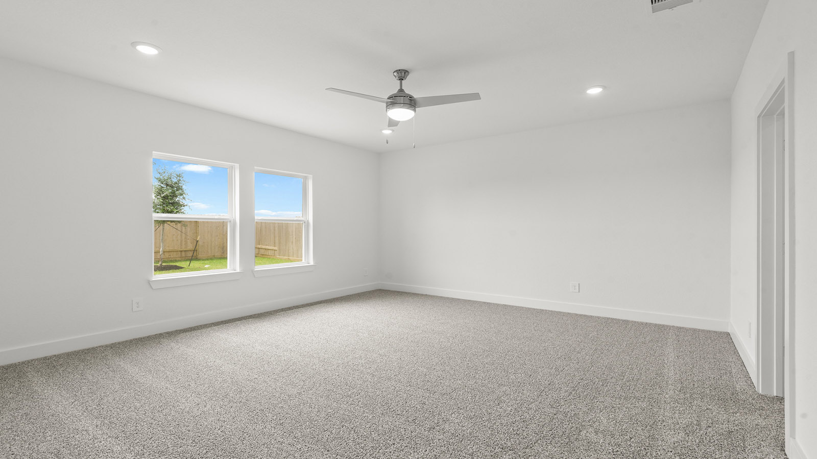 Primary bedroom with bright windows