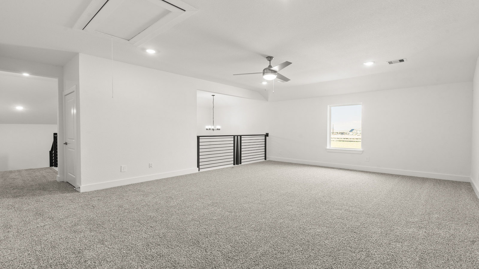 Second story game room with carpet flooring
