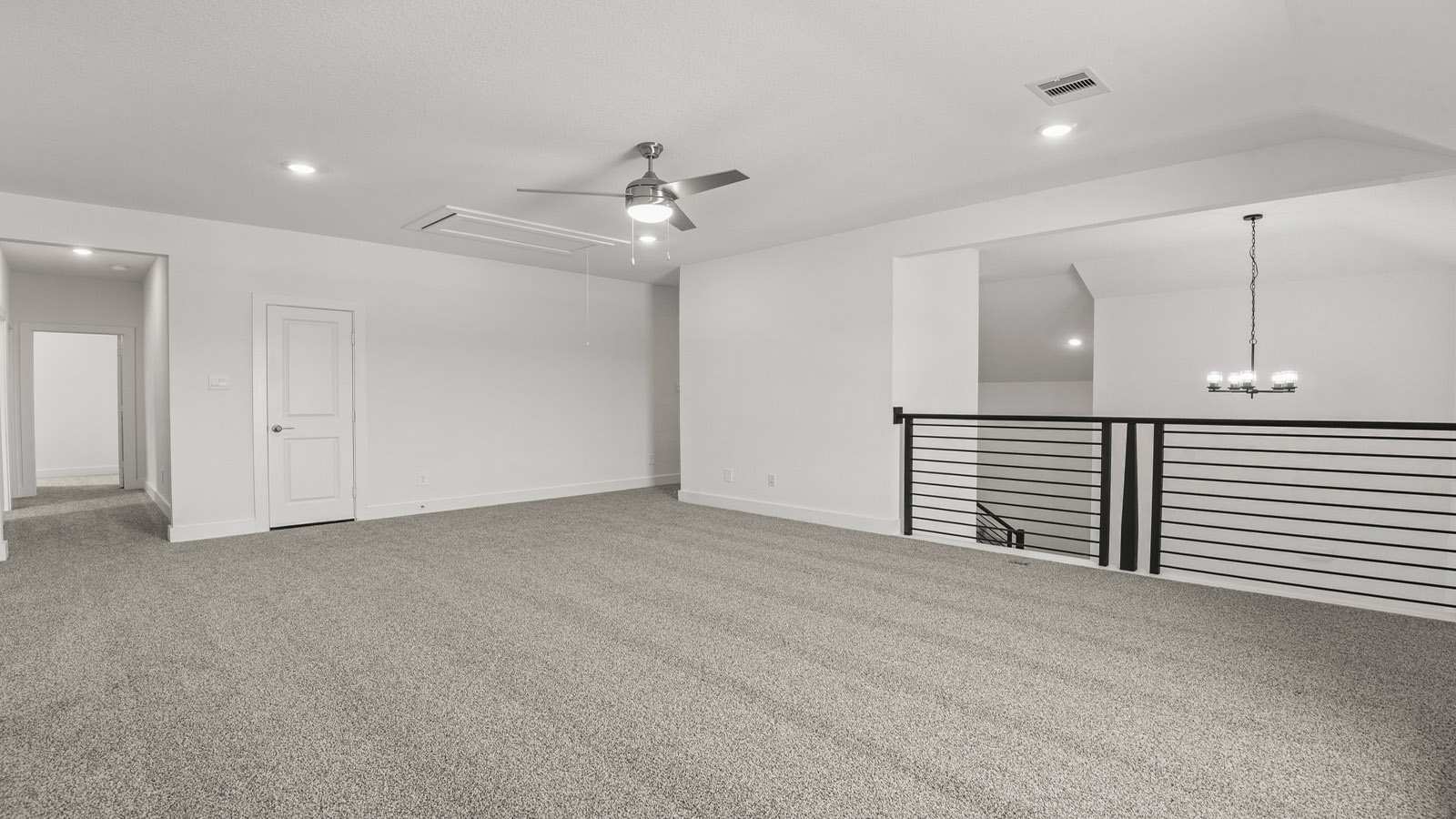 Second story game room with carpet flooring