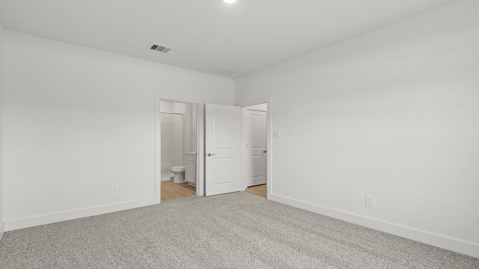 Primary bedroom with carpet flooring