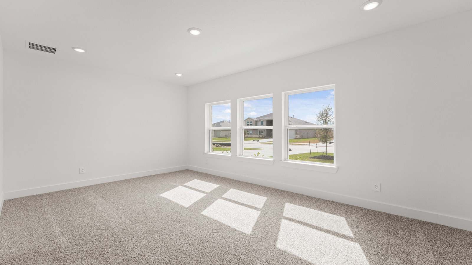 Primary bedroom with carpet flooring