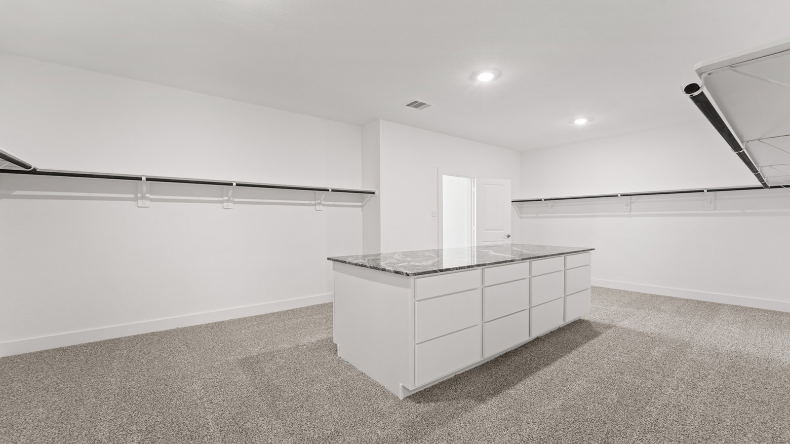 walk in closet with island storage