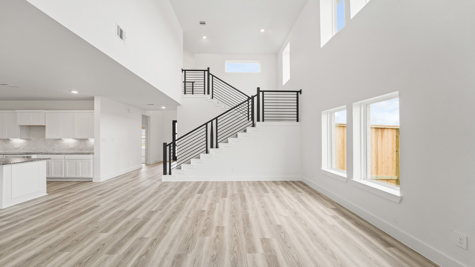Spacious living area with vinyl flooring