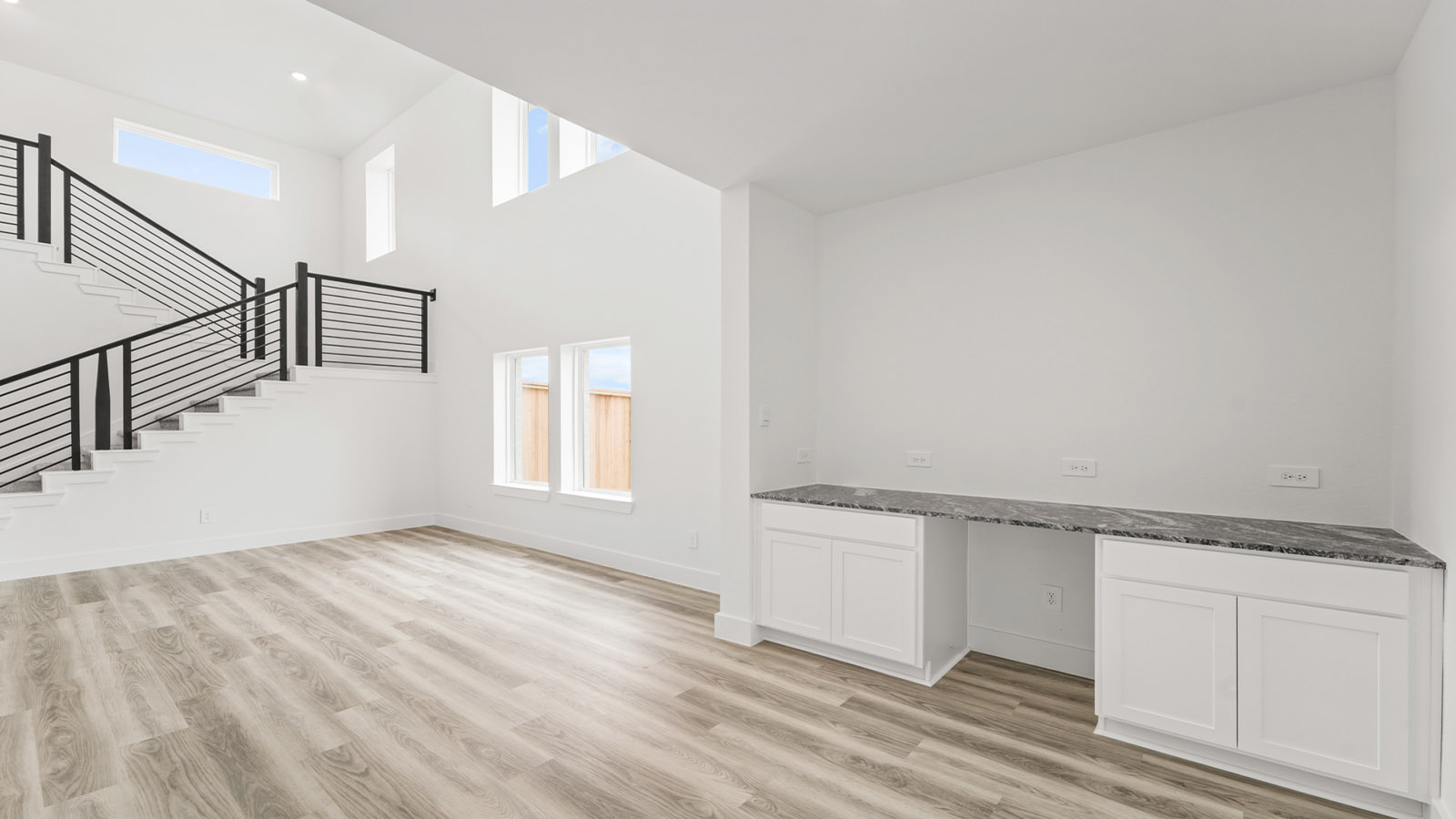 Spacious living area with vinyl flooring