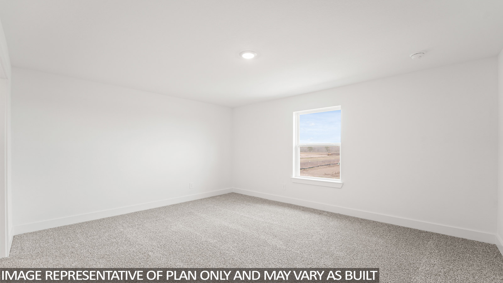 Secondary bedroom with carpet flooring