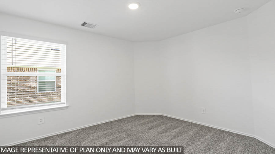 Secondary bedroom with carpet flooring