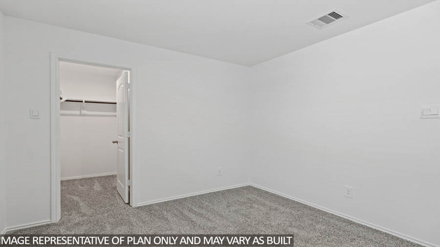 Secondary bedroom with carpet flooring