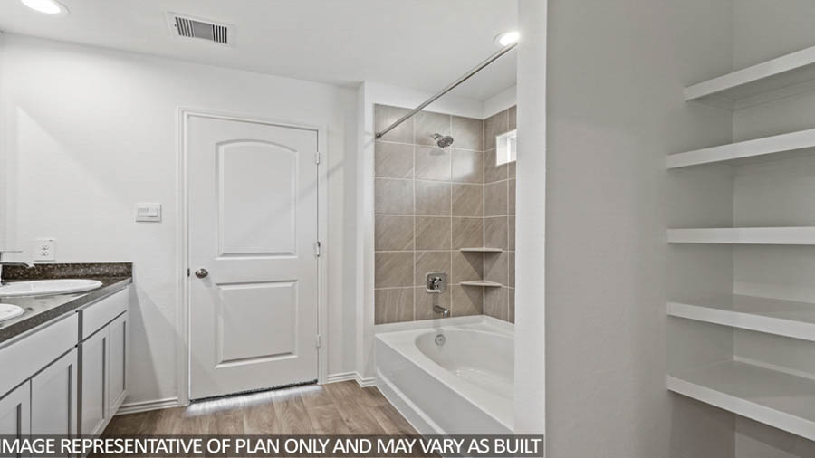 primary bathroom with linen nook and tub/shower combo
