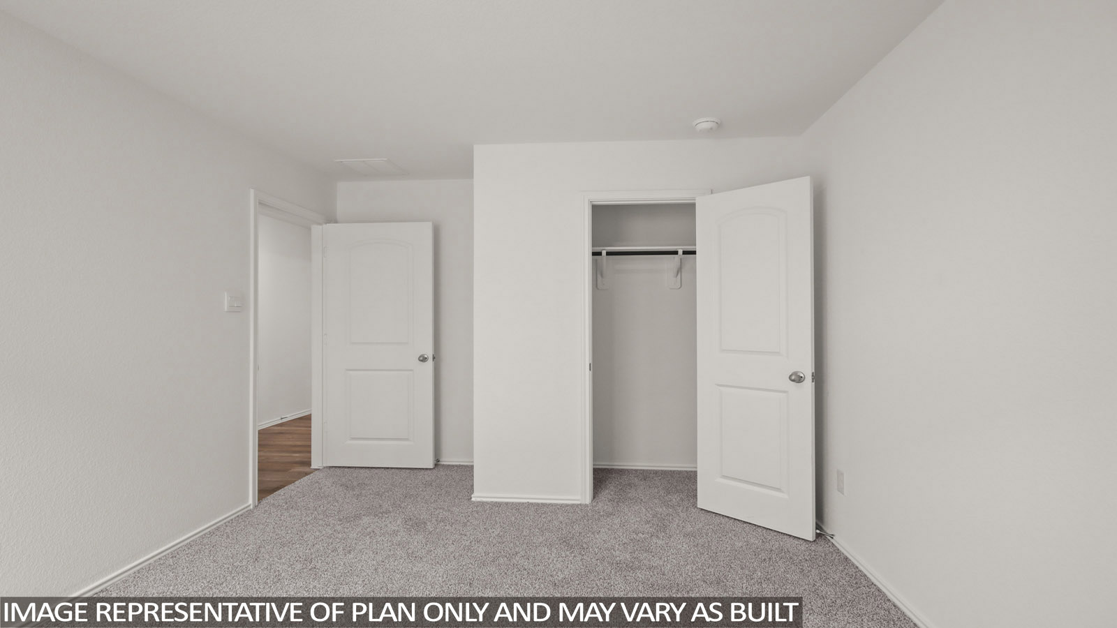 Secondary bedroom with carpet flooring