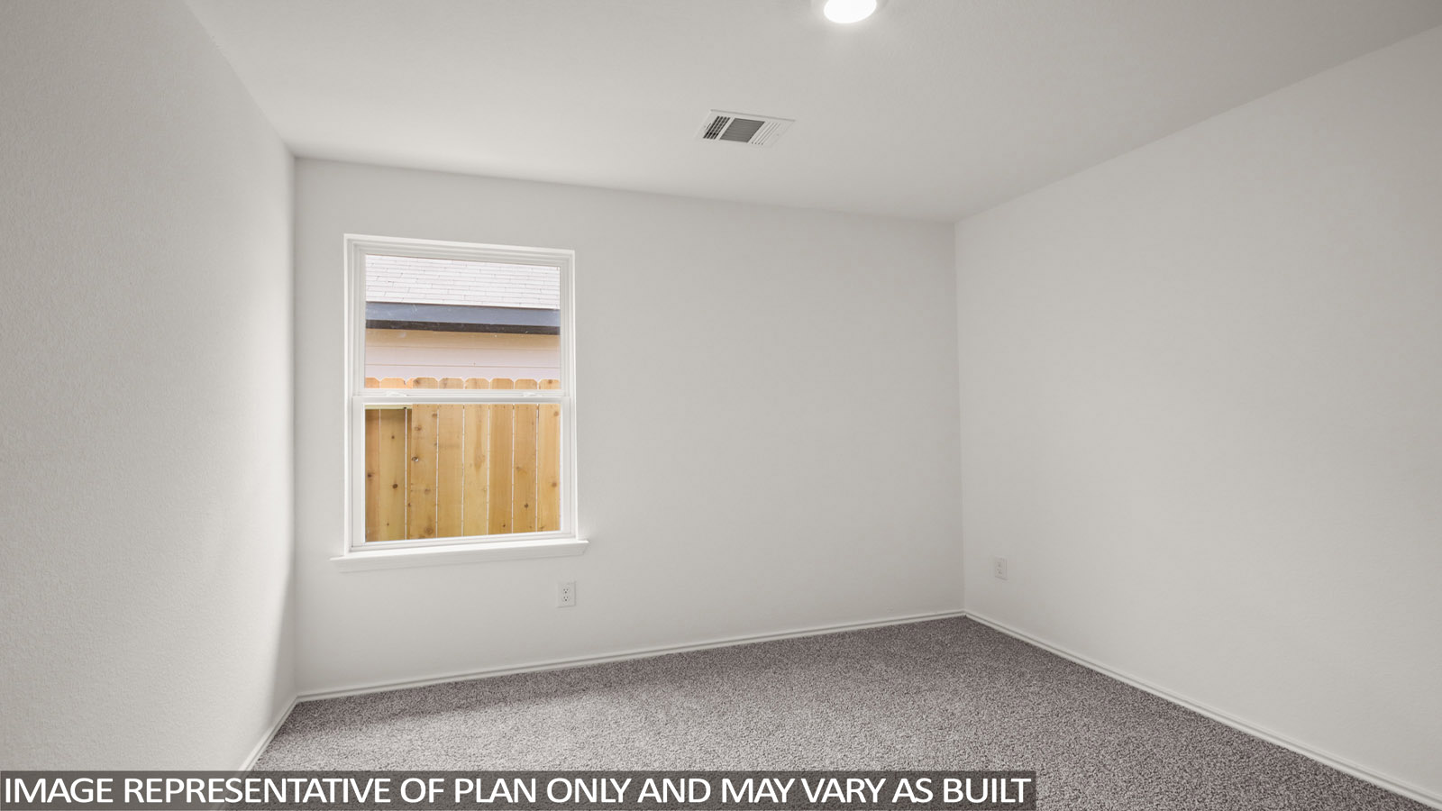 Secondary bedroom with carpet flooring