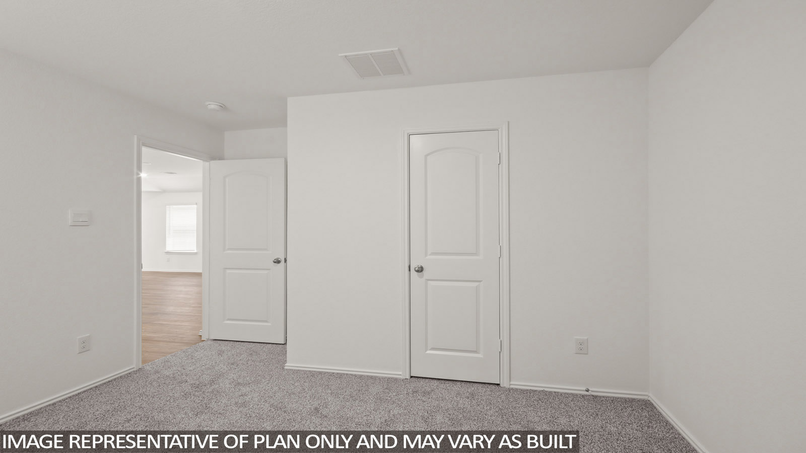 Secondary bedroom with carpet flooring