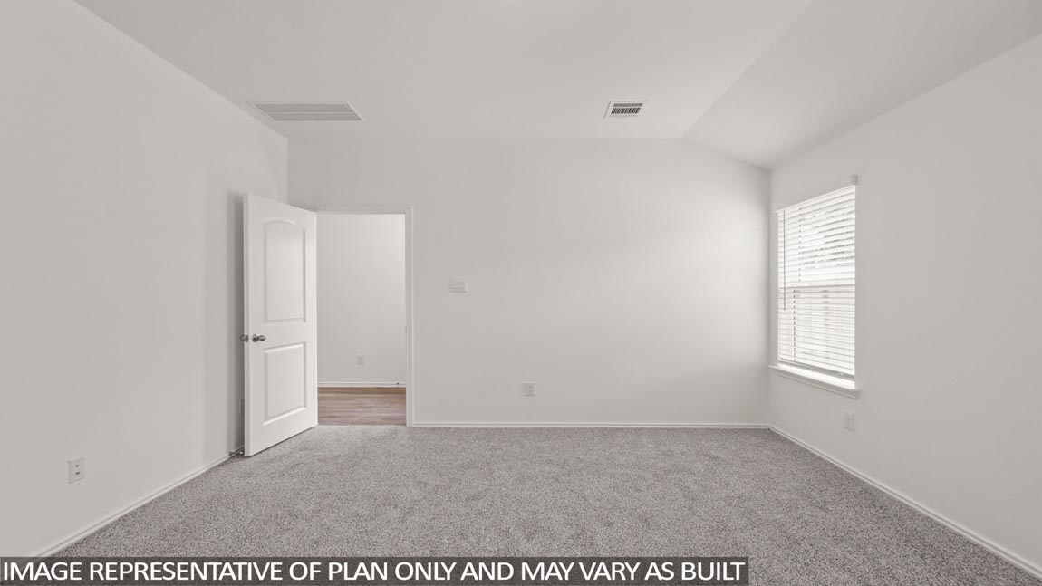 Primary bedroom with carpet flooring