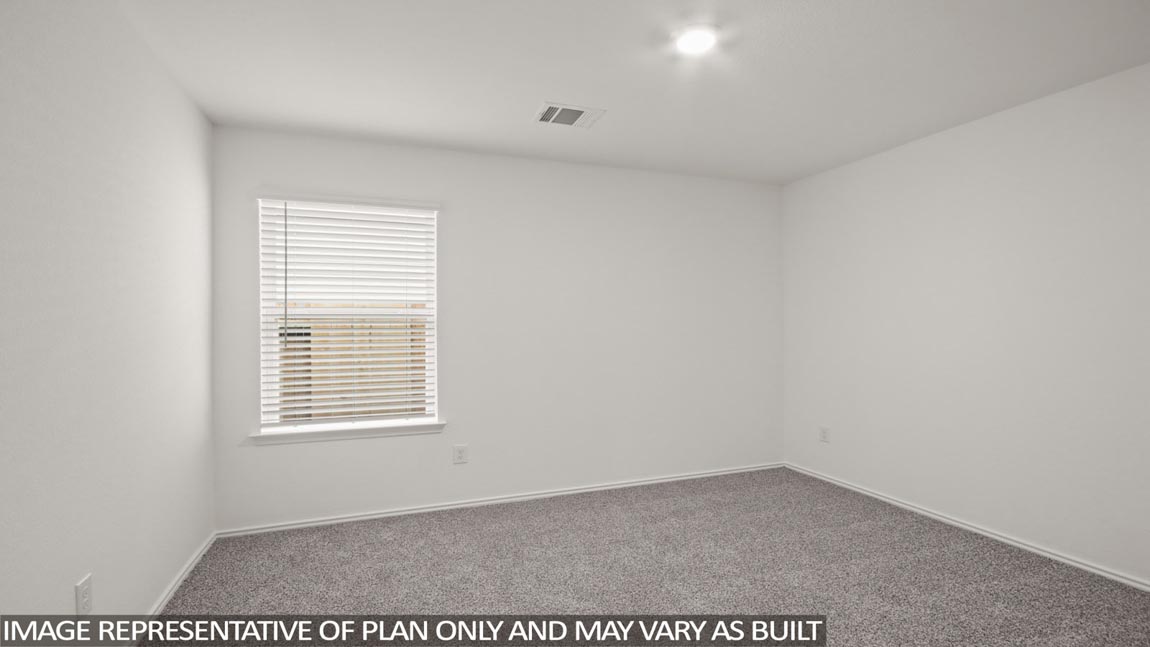 Secondary bedroom with carpet flooring