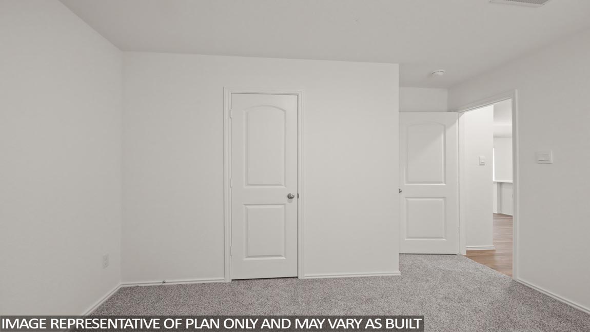Secondary bedroom with carpet flooring