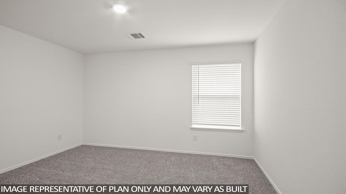 Secondary bedroom with carpet flooring