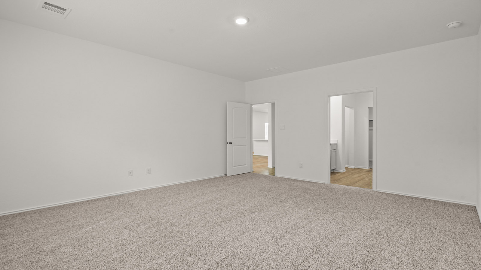 Primary bedroom with carpet flooring