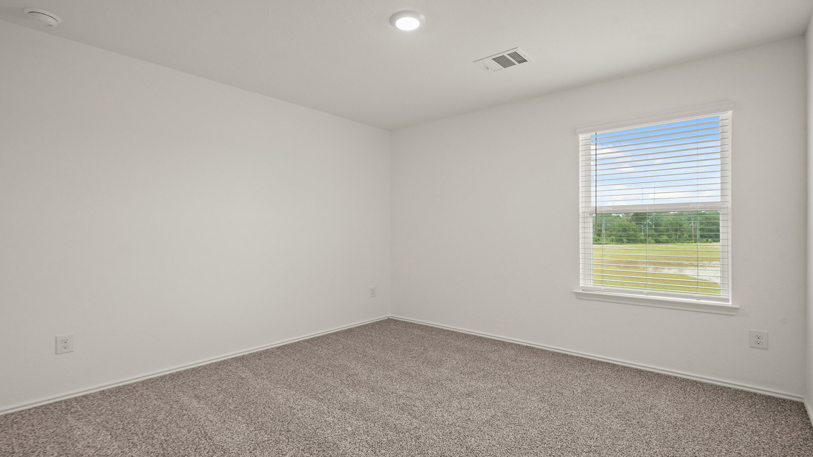 Secondary bedroom with carpet flooring