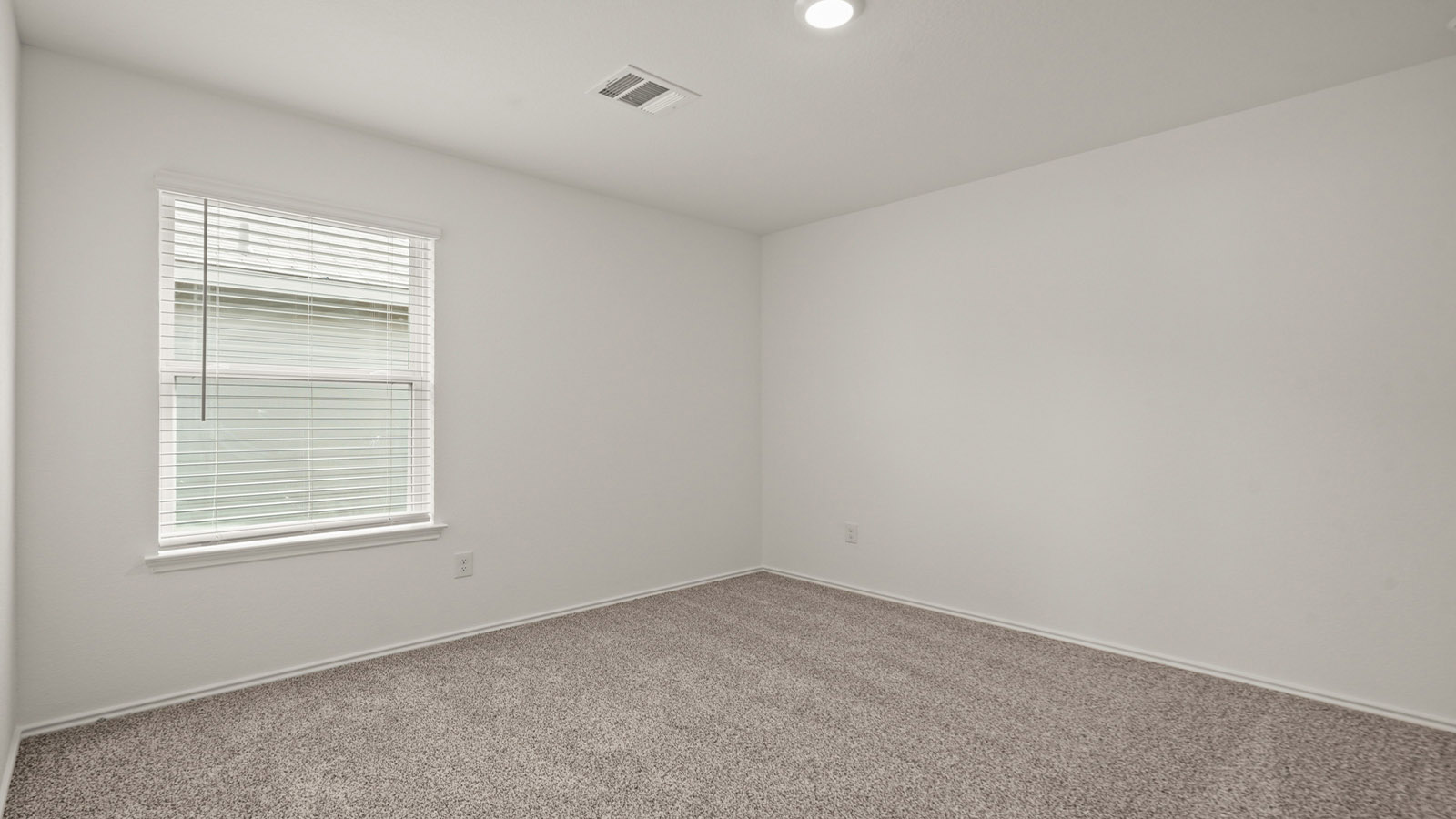Secondary bedroom with carpet flooring