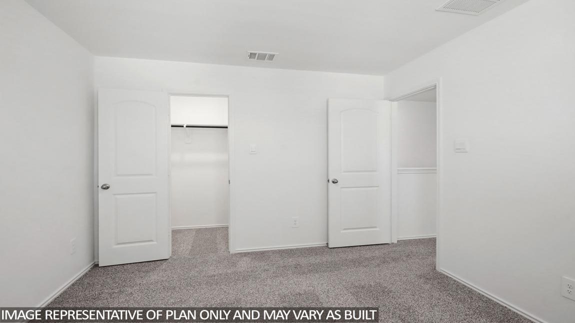 Secondary bedroom with carpet flooring