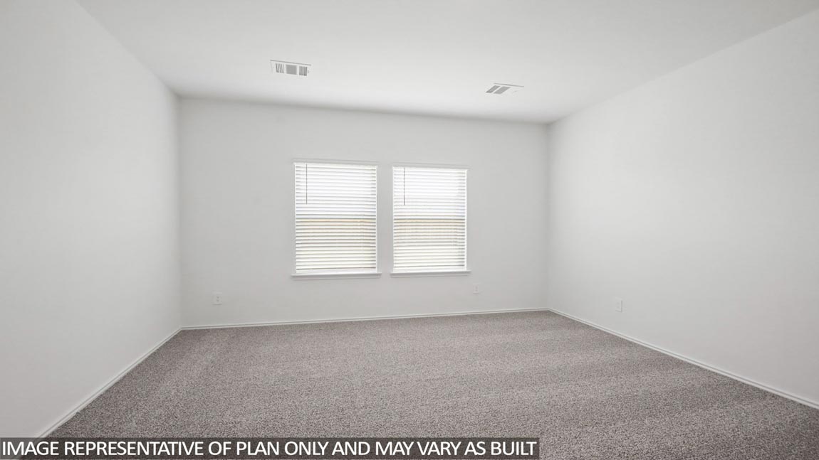Primary bedroom with carpet flooring