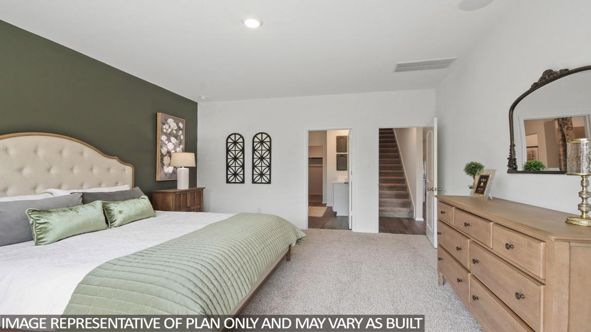 Primary bedroom with carpet flooring