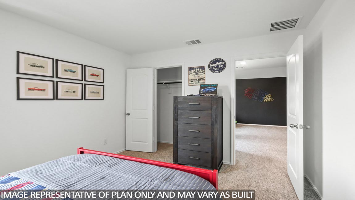 Secondary bedroom with carpet flooring