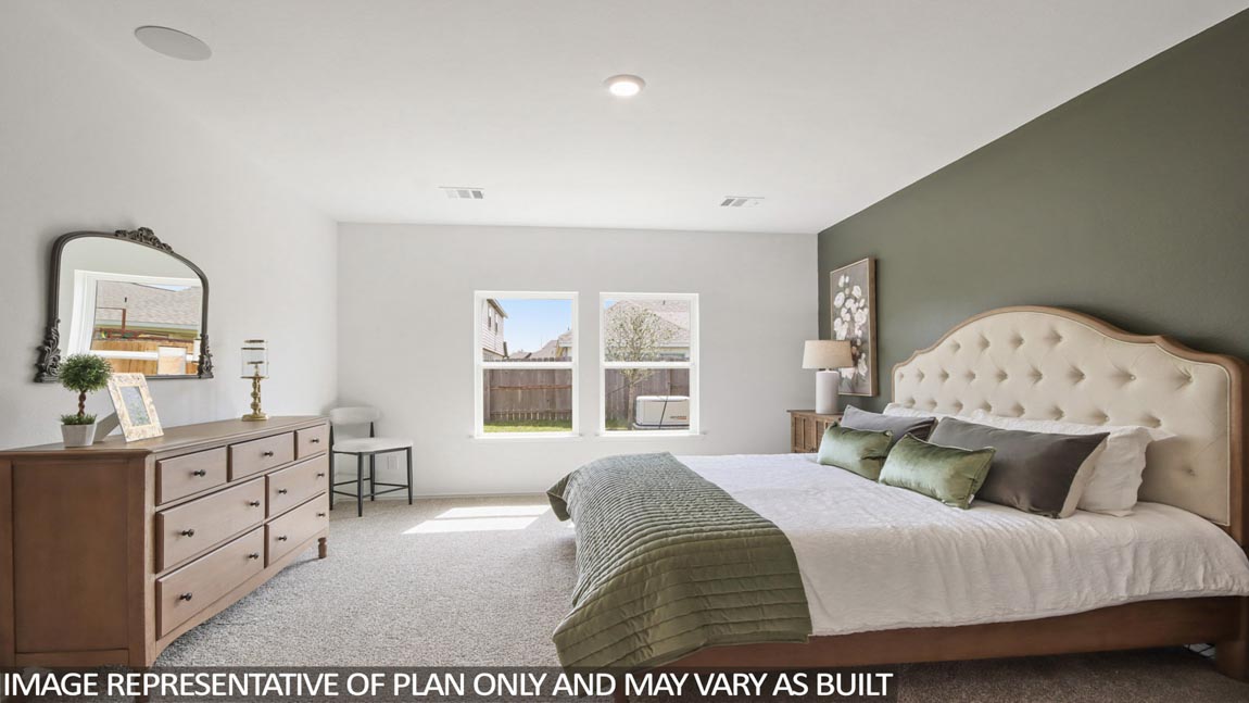 Primary bedroom with carpet flooring
