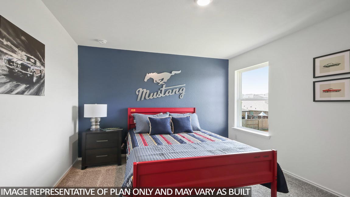 Secondary bedroom with carpet flooring