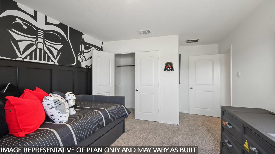 Secondary bedroom with carpet flooring