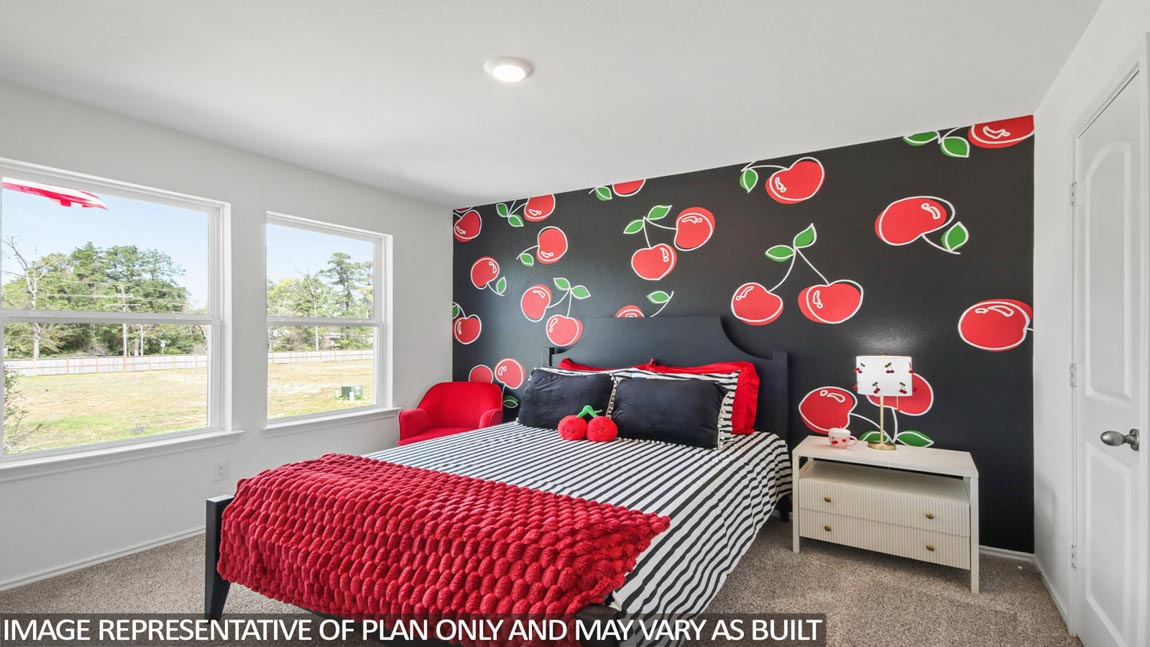 Secondary bedroom with carpet flooring