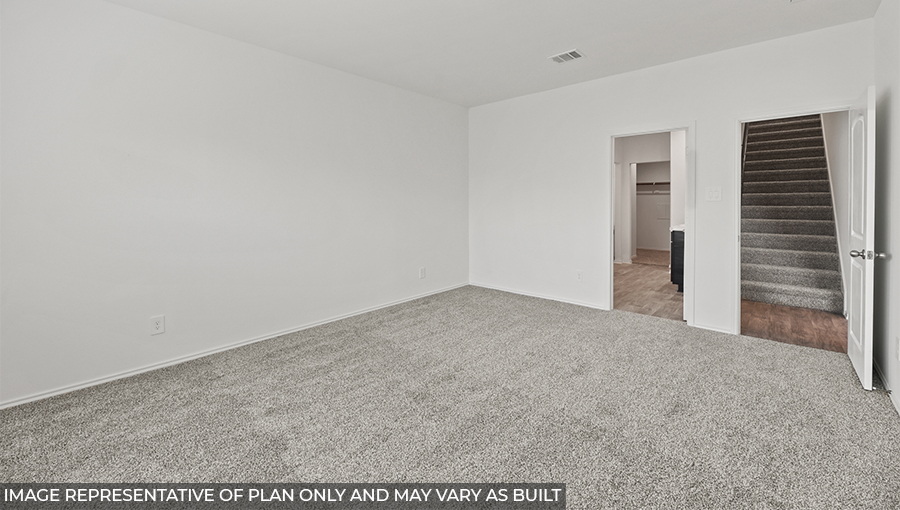Secondary bedroom with carpet flooring and a tall closet.