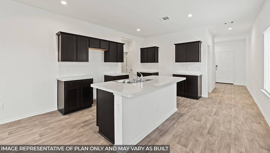 Kitchen with island and stainless-steel appliances.